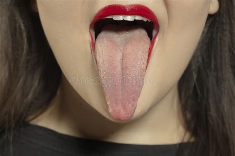Smiling Girl Opening Her Mouth With Red Lips And Showing The Long Big