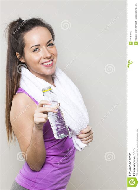 Young Fitness Girl Showing A Bottle Of Water At The Gym Stock Image