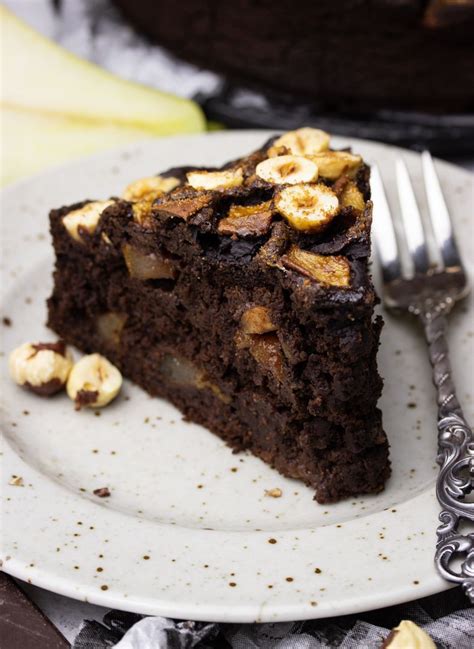 A Piece Of Chocolate Cake On A Plate With A Fork Next To It And Bananas