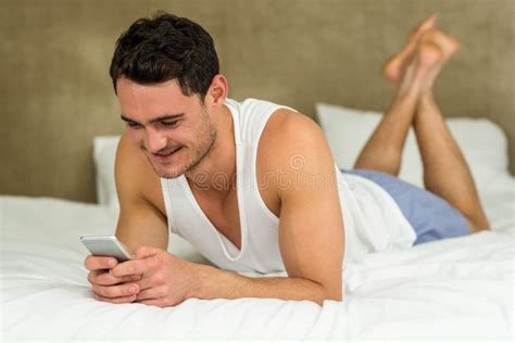 Young Man Lying On Bed With His Phone Stock Image Image Of Holding Attractive 66932153