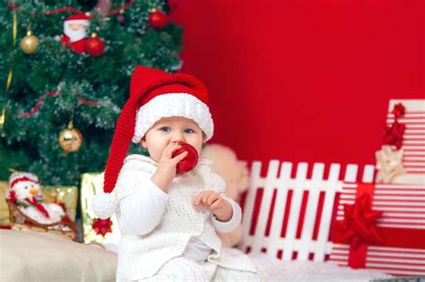 Premium Photo Happy Baby In Christmas Interior Santas Cap With Ts