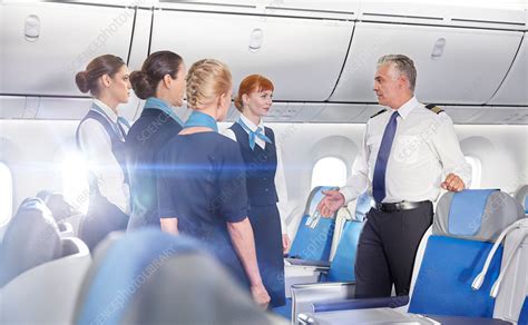 Pilot And Flight Attendants Talking Preparing Stock Image F020