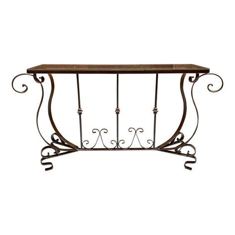 A Wrought Iron Table With Glass Top On A White Background For Display