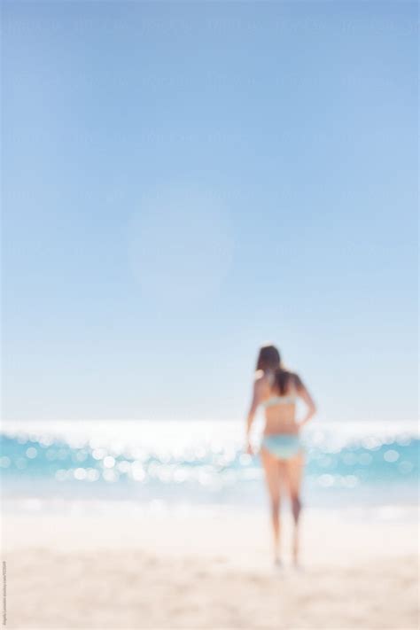 Teenage Girl In A Turquoise Bikini Walking To The Sparkling Water Of The Indian Ocean By