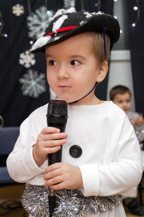 An Adorable Child 3 Years Old Singing Or Talking Into A Microphone