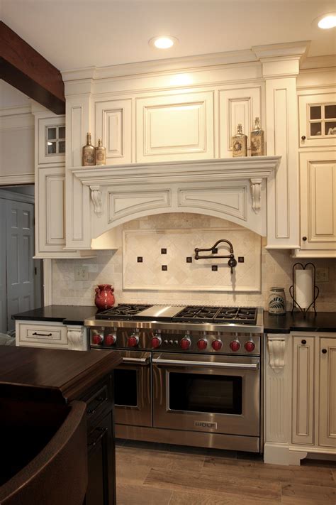 Our custom range hood features a board and batten design with reclaimed wood. Mantle wood hood - Leesburg Va Kitchen | Kitchen design ...