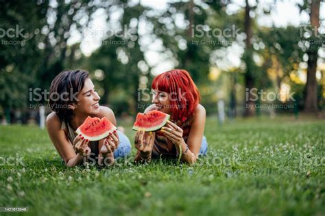 Lovely Lesbian Girls Looking At Each Other Eating A Watermelon Stock