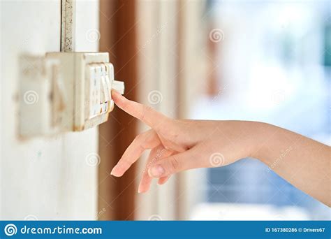 Female Hand To Turn Off The Light Switch Side View Stock Photo