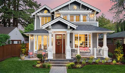 Beautiful Luxury Home Exterior With Glowing Interior Lights At Sunset