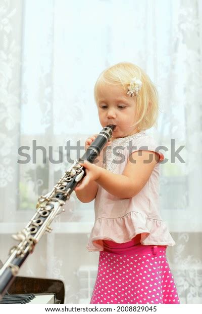 Little Girl Plays Clarinet Teaching Children Stock Photo 2008829045