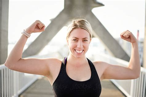 A Confident Woman Body Builder Shows Off Her Muscles By Carli Teteris