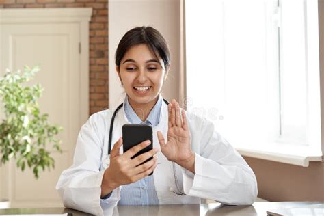 Smiling Indian Doctor Video Conference Call Patient In Online Mobile