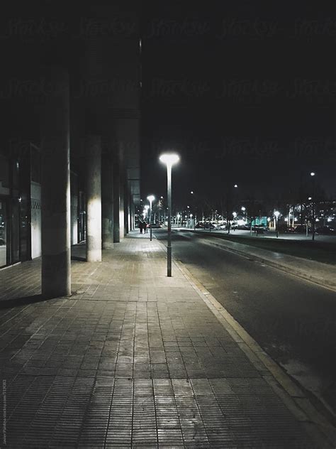 Scene Of A Dark Street At Night Lit By A Lamp Stocksy United
