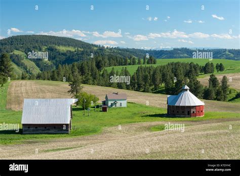 Farmhouse And Barns Near Flora Oregon With The Wallowa Mountains In