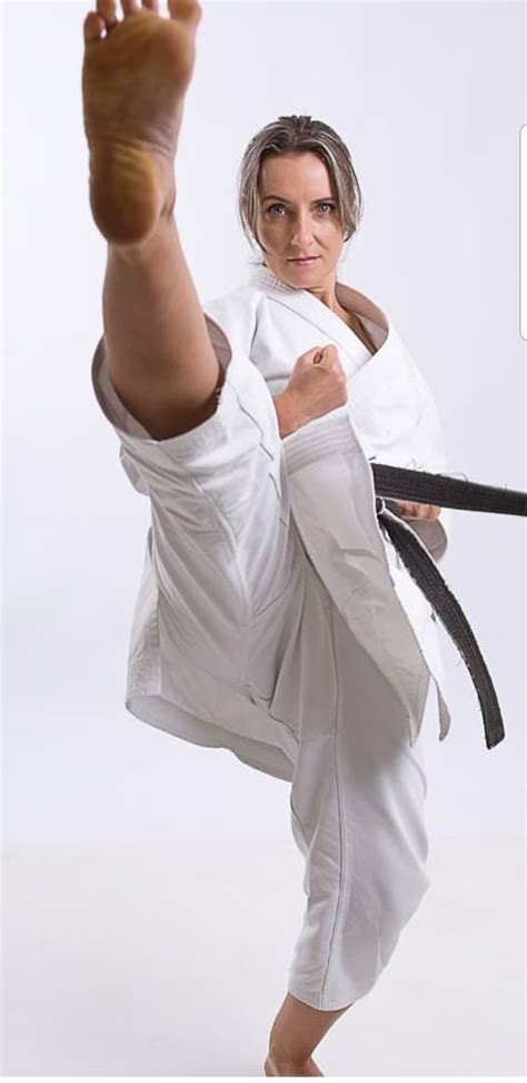 A Woman Is Doing Karate On A White Background