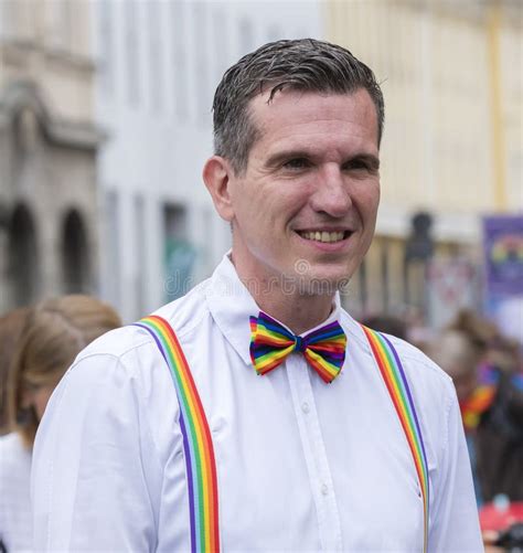 2019 a smiling man with a rainbow bowtie attending the gay pride parade also known as
