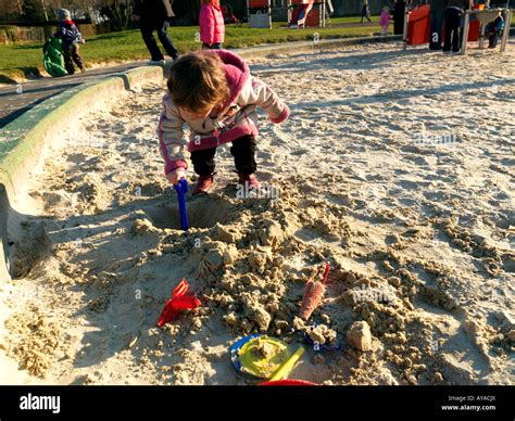 Child Digging Hole In Sandpit Stock Photo Alamy