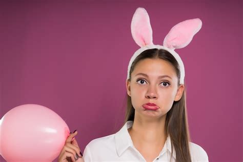 Premium Photo Girl Pokes Her Face And Holds A Pink Ball In Her Hands