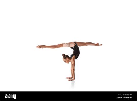 Twine In Hand Stand Portrait Of Junior Gymnast In Black Sport Swimsuit