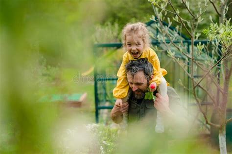 father with his little daughter bonding in front of eco greenhouse sustainable lifestyle stock