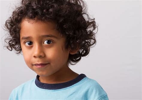 Layers of one and the same form are textured with a graded technique and designed to emphasize the natural look of the curls. Top 10 Curly Hairstyles for Little Black Boys (August. 2020)