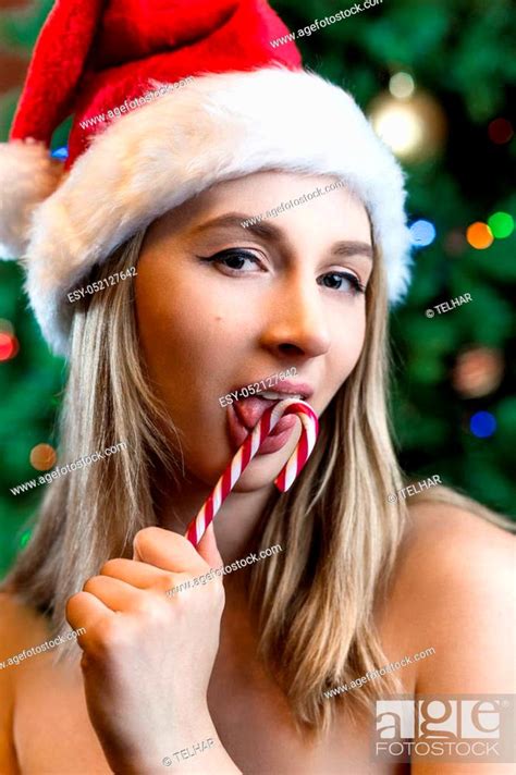 Beautiful Sexy Young Blonde Girl With Hair In Red Santa Hat Stock