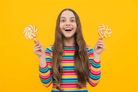 Teenager Girl Eating Sugar Lollypop Candy And Sweets For Kids Stock