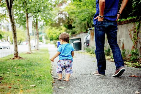 Father And Baby Son Walking Outdoors Stock Photo Dissolve