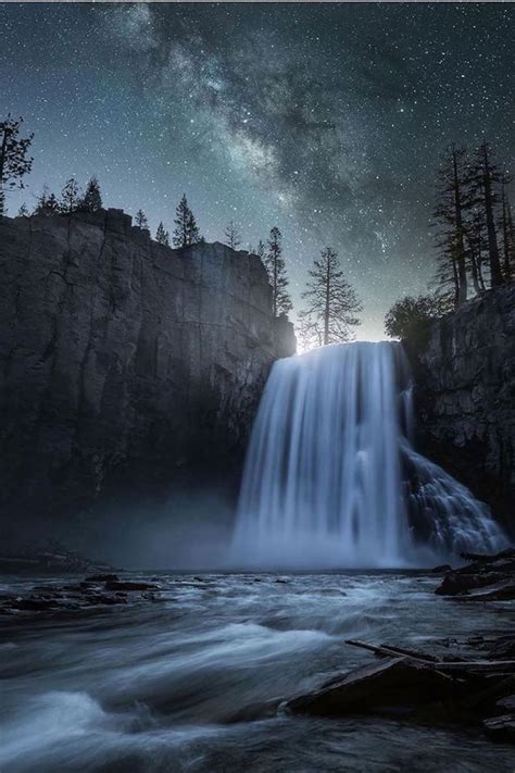 A Waterfall Is Shown With The Milky Sky In The Background