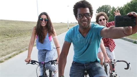 Three Young Adults Having Fun Cycling And Taking Selfies Stock Footage Video Of Adult Cell
