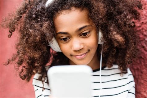 Beautiful African American Girl With Curly Hair Holding Smart Phone