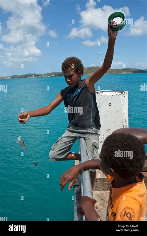 Torres Strait Islander Kids Fishing Off The Jetty At Horn Island