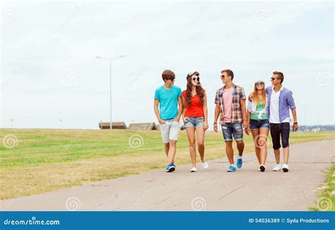 Group Of Smiling Teenagers Walking Outdoors Stock Image Image Of