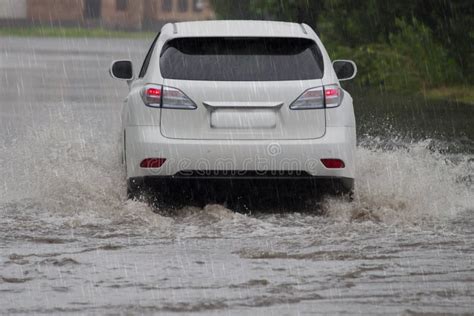 red car rides in heavy rain on a flooded road stock image image of motion flood 146720809