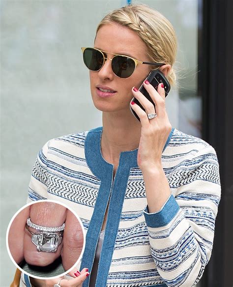A Woman Wearing Sunglasses Talking On A Cell Phone And Holding A Ring In Her Hand