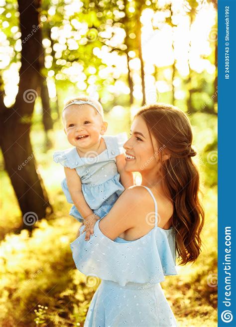 Portrait Of Overjoyed Mother With Adorable Daughter Walking At The Park Smiling Caring Woman