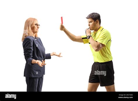 Football Referee Blowing A Whistle And Showing A Red Card To A