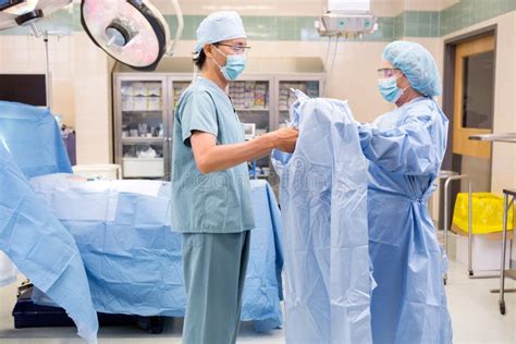 Scrub Nurse Assisting Surgeon With Gown Stock Image Image 36579551
