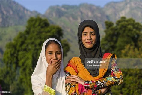 A Portrait Of Two Kashmiri Girls Covering Their Heads With A White