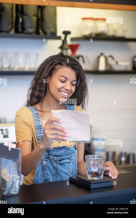 Smiling Woman Pouring Coffee Beans Into Glass Stock Photo Alamy