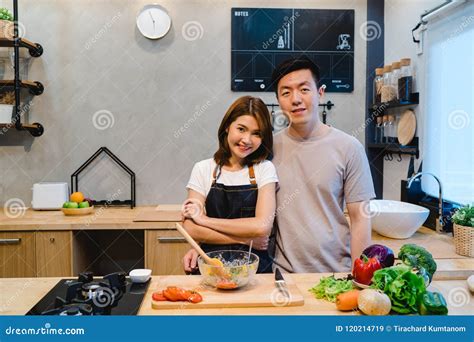 asian couple prepare food together beautiful happy asian man and woman are cooking in the