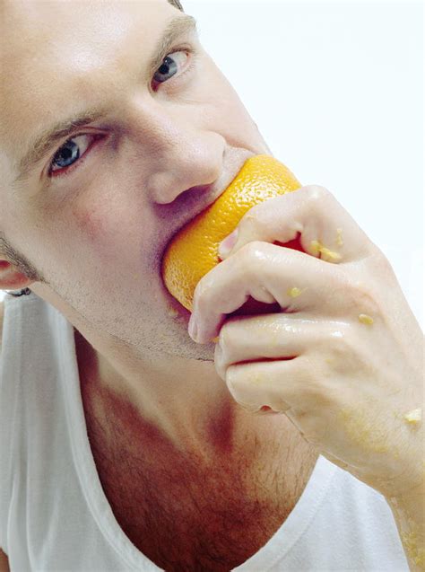 Man Eating Orange Photograph By Jason Kelvinscience Photo Libray