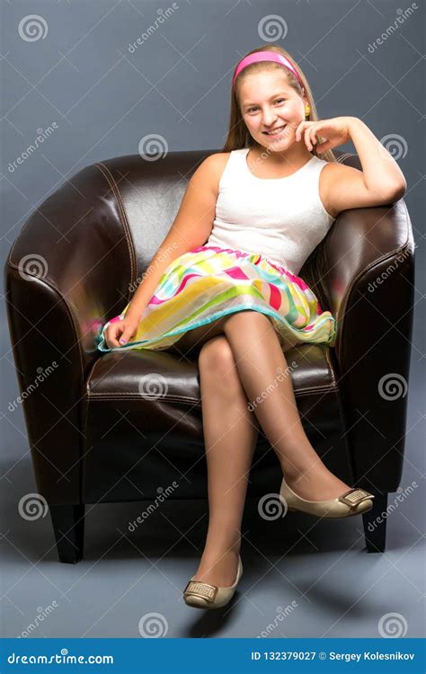 A Teenage Girl Is Sitting On A Leather Chair Stock Image Image Of