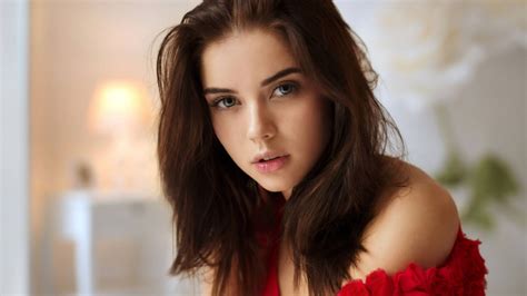 download elegant mature woman in a vibrant red top wallpaper