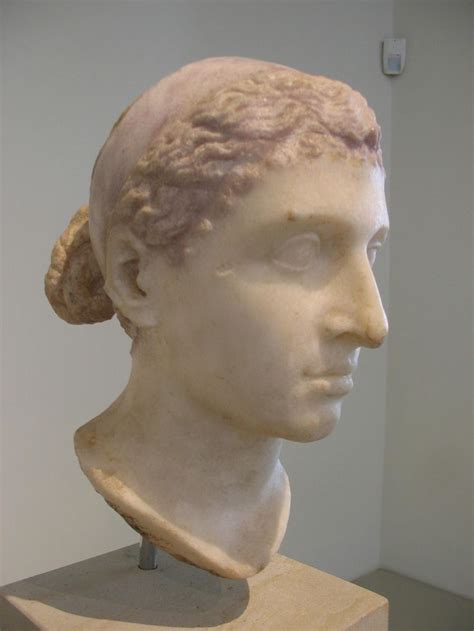 A Statue Of A Womans Head On Display In A Museum