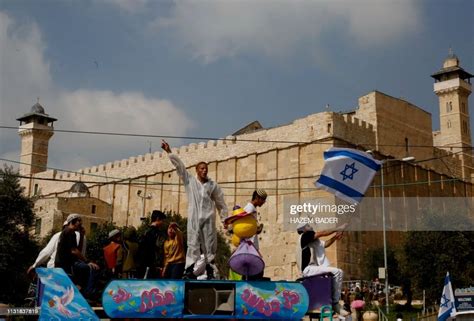 Israeli Settlers Celebrate The Jewish Purim Holiday In Front Of News