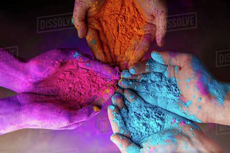 Cropped View Of Hands With Holi Powder For Hindu Spring Festival Of