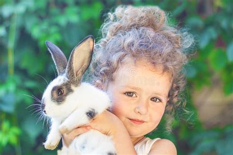 Little Beautiful Girl Hugings A Baby Rabbit Happy Cute Child Playing