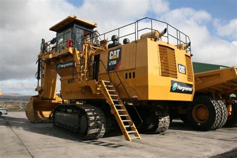 A Large Yellow Bulldozer Sitting On Top Of A Parking Lot