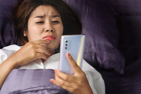 Asian Woman Watching Drama Late At Night In Bed Hand Holding Smart Phone Stock Photo Image Of
